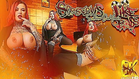 Sexy redhead in black stockings and sexy red dress is masturbating