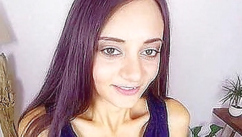 Sexy female is playing with a big dildo in her favorite bedroom