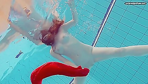 Sexy brunette naked in the pool in her beach bikini