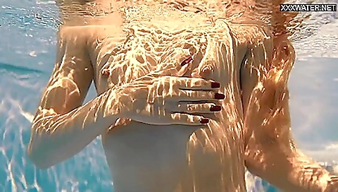 Beautiful brunette in bikini shows her body in the shower