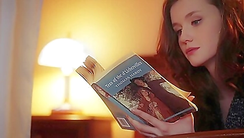 Sexy brunette with a sexy dress is alone on the couch