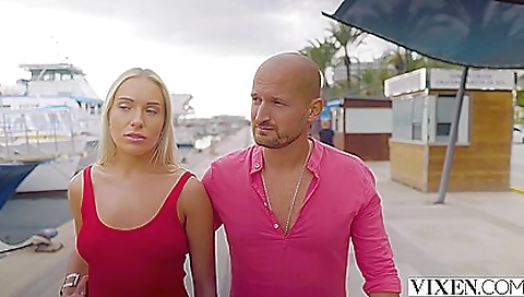 Busty blonde milf in a red dress and stockings on a bike