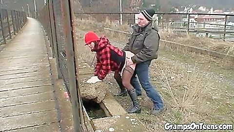 Busty brunette fucks an old man in front of the street